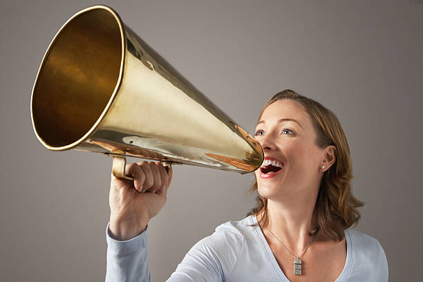 istock Businesswoman Shouting Through Megaphone 529647389