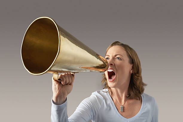 istock Angry Businesswoman Shouting Through Megaphone 529647391