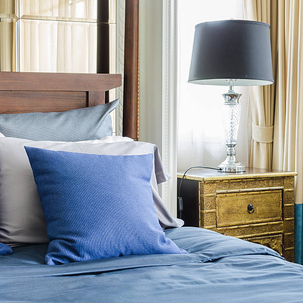 istock blue pillows on wooden classic bed 529648281