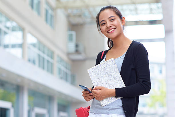 istock young asian college student smile at camera 529648727