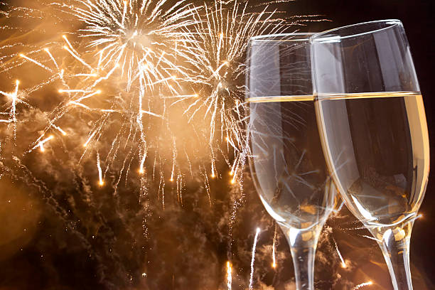 istock Glasses with champagne against fireworks 529650407