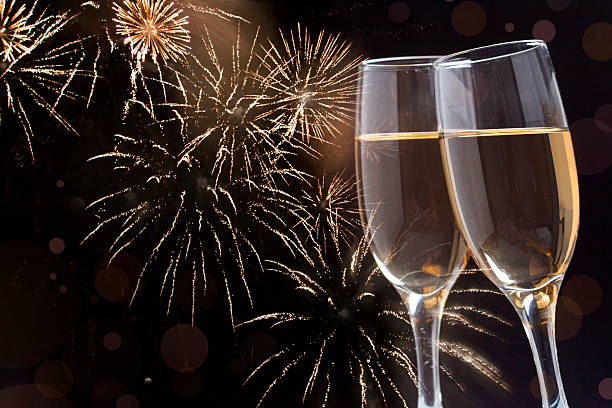 istock Glasses with champagne against fireworks 529650411