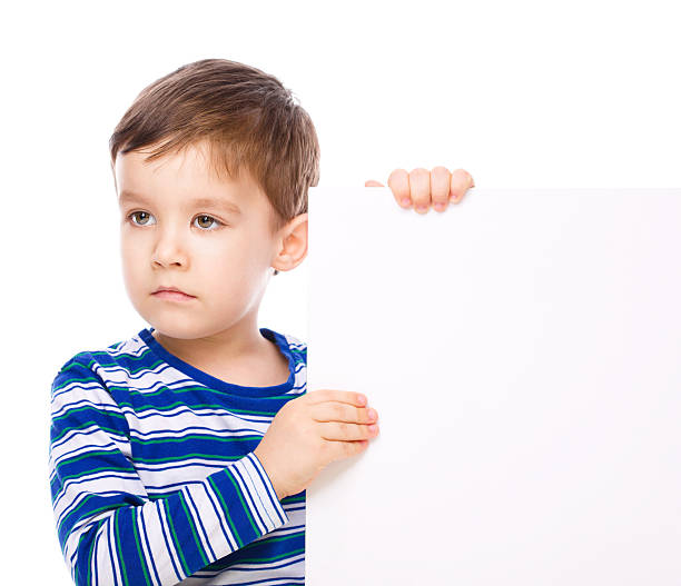 istock Cute boy is holding blank banner 529652573