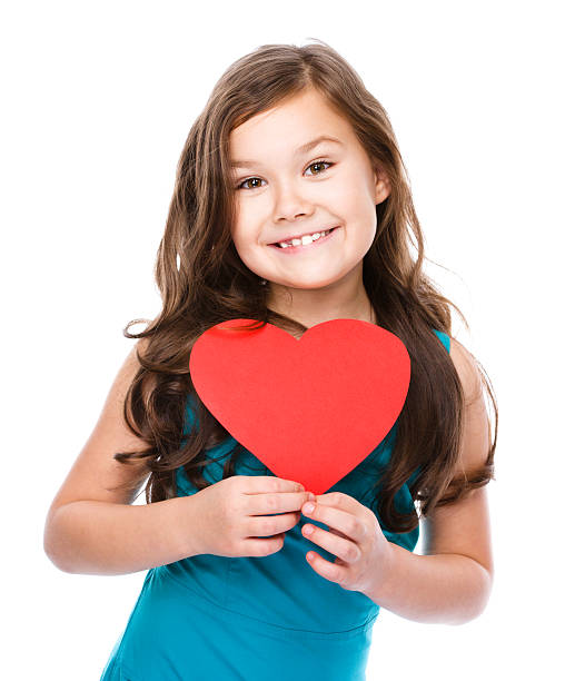istock Happiness - smiling girl with red heart 529652597