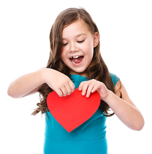 istock Happiness - smiling girl with red heart 529652613