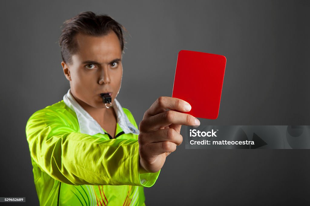 Soccer referee showing the red card isolated on gray background Referee Stock Photo