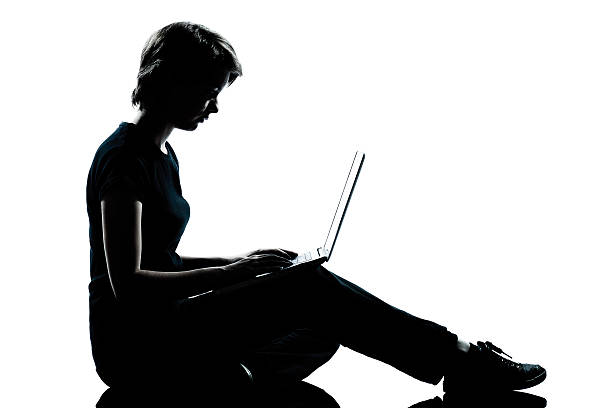 istock one young teenager girl silhouette computer computing laptop 529653715