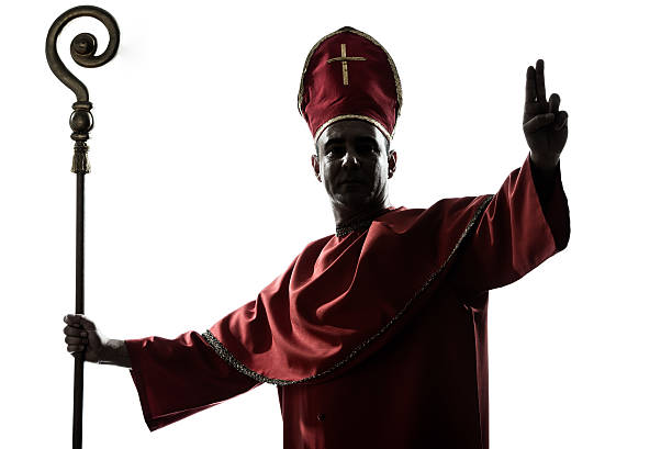 istock man cardinal bishop silhouette saluting blessing 529654207