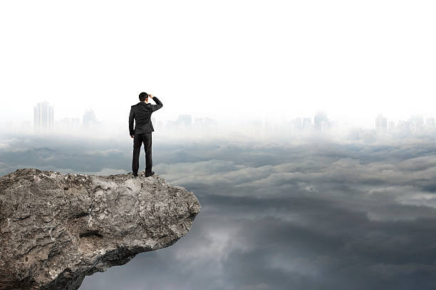 Photo of man looking on cliff with gray cloudy sky cityscape  background