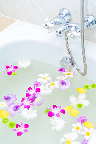 istock flower and mineral water in bathtub 529654627
