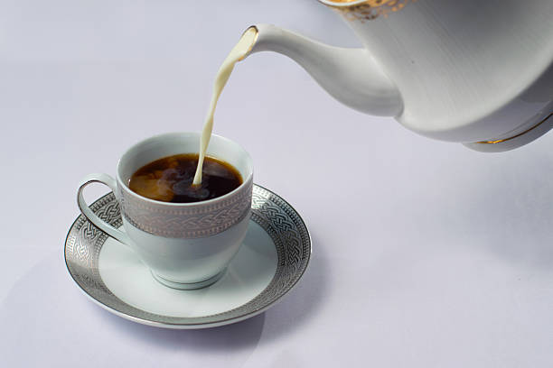 istock Milk being poured into black coffee 529654693