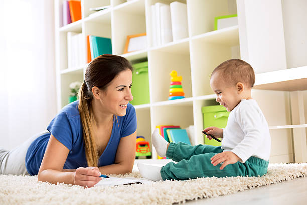 istock Happy smiling family drawing together on floor 529656778