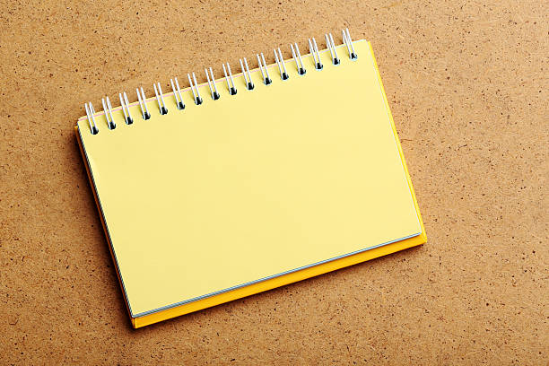 istock Notebook on the brown wooden background 529657150