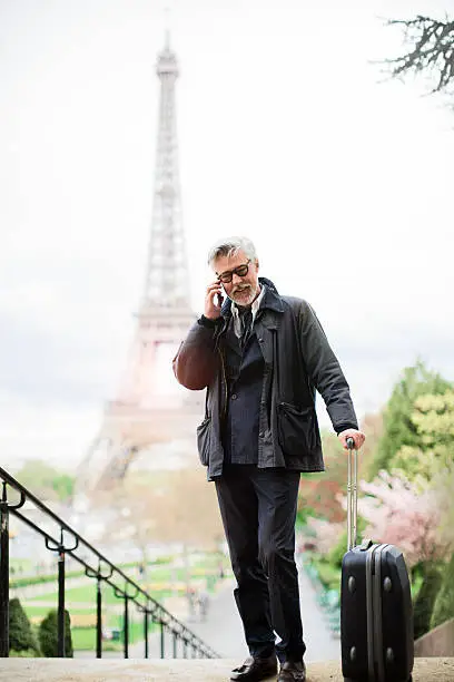 Man using a smartphone at Trocadero near EiffelTower