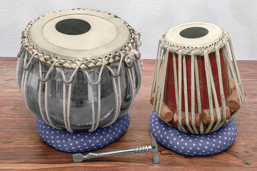 set of traditional tabla drums on wooden surface