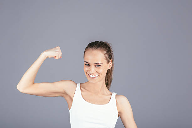 istock Beautiful girl showing muscles 529662208
