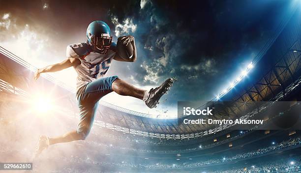 Football Player Runs With The Ball Stock Photo - Download Image Now - American Football - Sport, American Football - Ball, American Football Player
