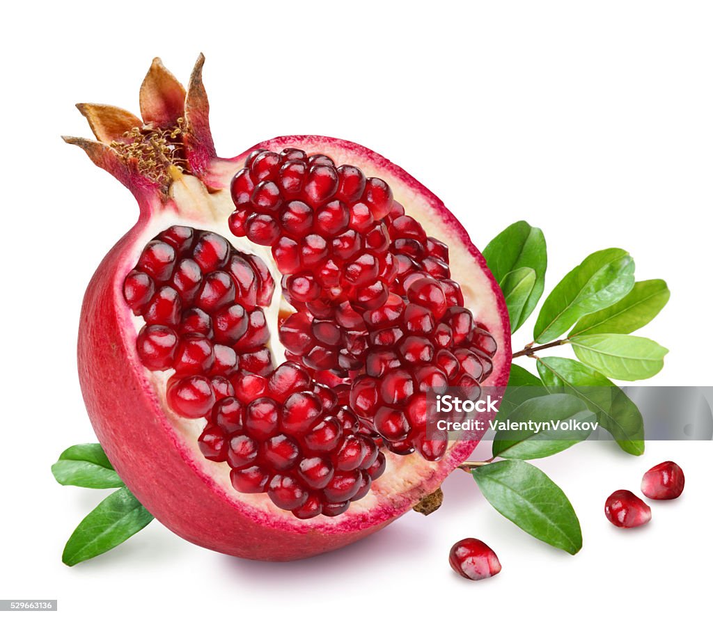 Pomegranate fruit with green leaves. Pomegranate fruit with green leaves on the white background. Pomegranate Stock Photo