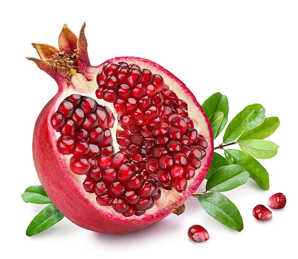 Pomegranate fruit with green leaves. stock photo