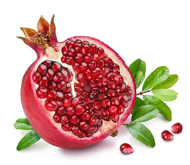Pomegranate fruit with green leaves on the white background.
