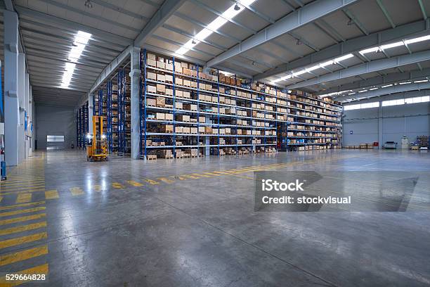 Forklift Carrying Cardboard Box In Warehouse Stock Photo - Download Image Now - Warehouse, Flooring, Industry