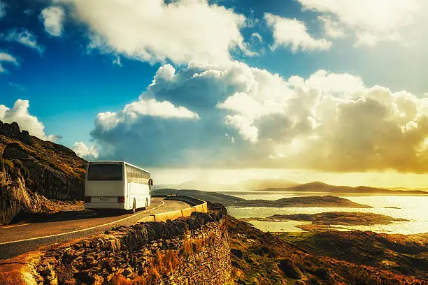 Tourist white bus on mountain road. Ring of Kerry, Ireland. Travel destination