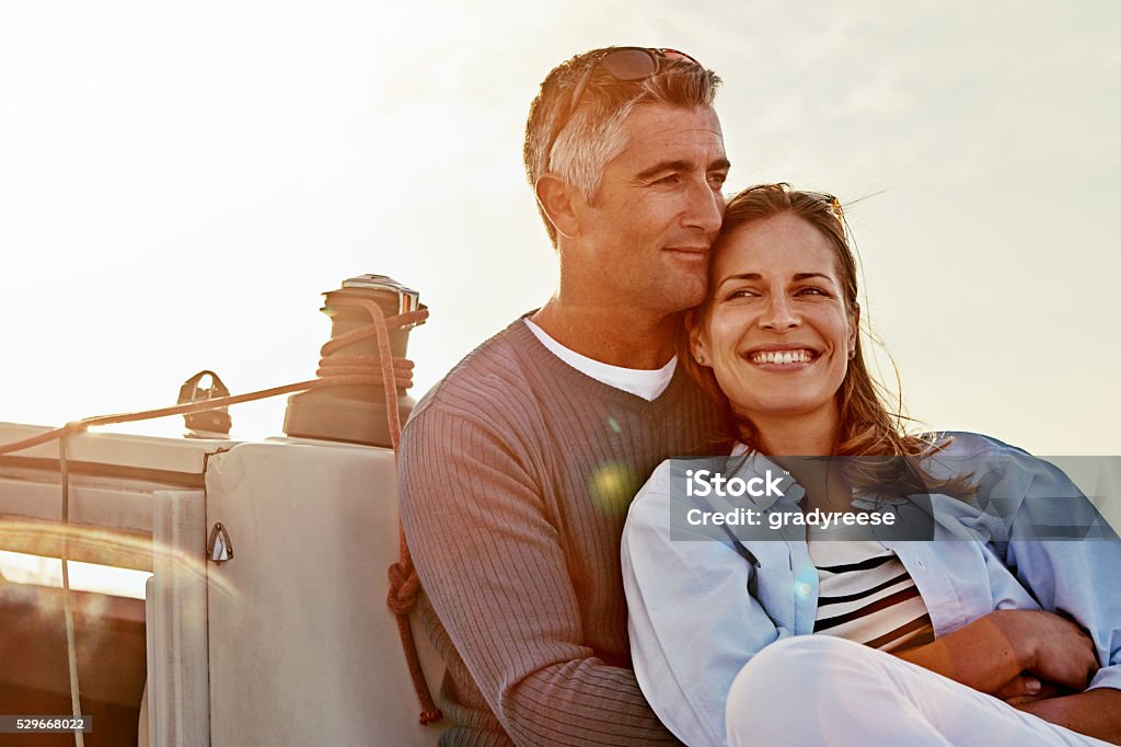 I want this moment to last forever Shot of a couple enjoying a boat cruise out on the ocean Couple - Relationship Stock Photo