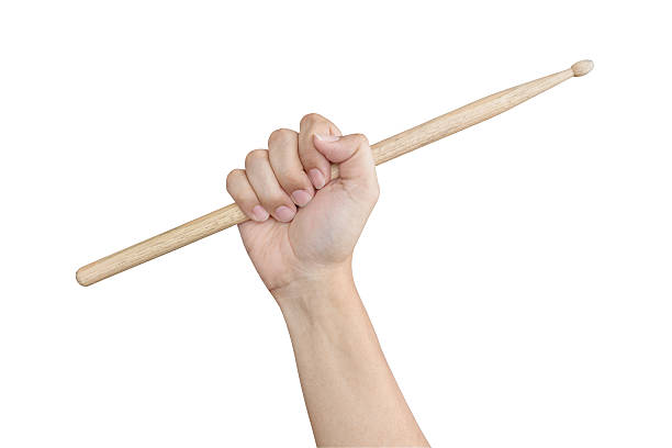 istock Male hand raising or holding drum sticks isolated on white 529668598