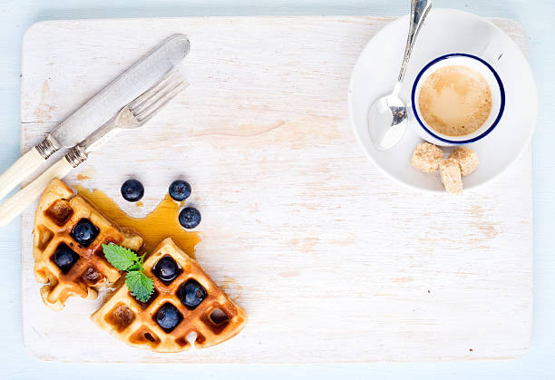 istock Espresso coffee cup, soft belgian waffles with fresh blueberries and 529668924