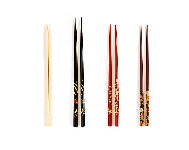 Four different pairs of chopsticks on white background