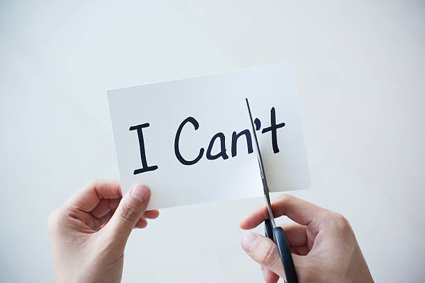 istock Using Scissors Cut Word on Paper Can't Become I Can 529677040