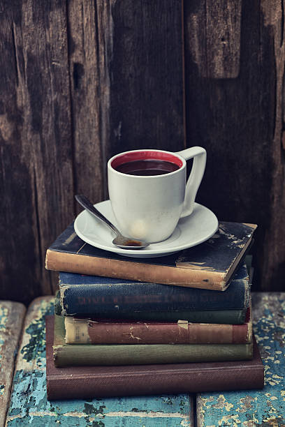 istock Coffee cup on some vintage books 529677268