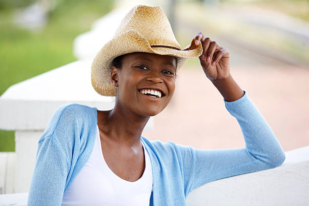 istock Smiling young african woman with cowboy hat 529678524