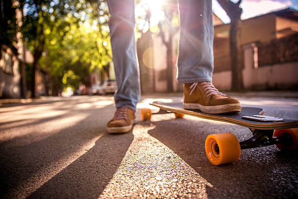istock Man with skateboard on the street at sunset light. 529679572