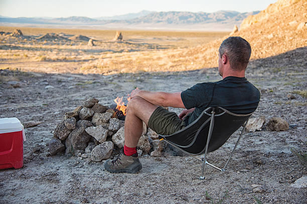 One Man Relaxing at the Campfire Looking at the View