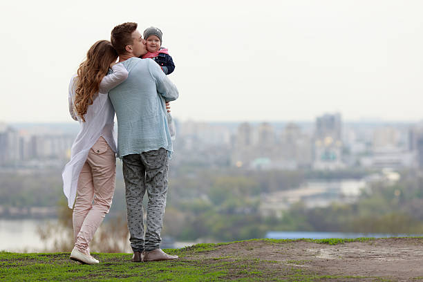 Happy young family on the city background stock photo