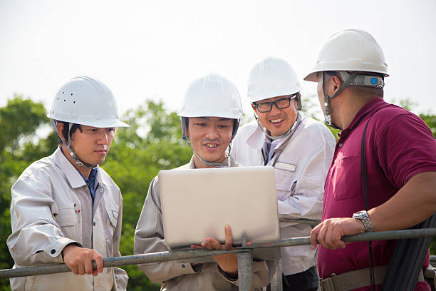 istock Team of construction workers looking at a laptop 529681392