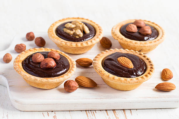 istock Nutty dessert - small tarts with different nuts and chocolate 529681584