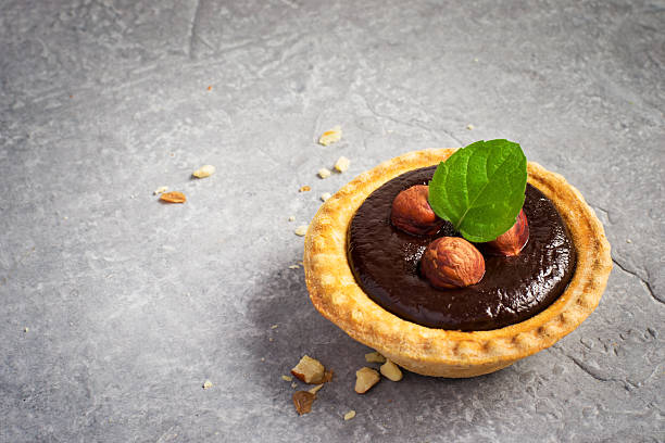 istock Small Chocolate Tart with almonds on a gray stone background 529682400