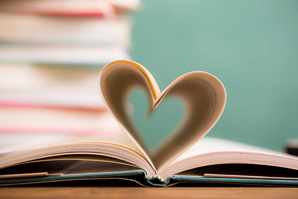 istock Love Reading!  Heart shape in open book pages. Education, school. 529683352