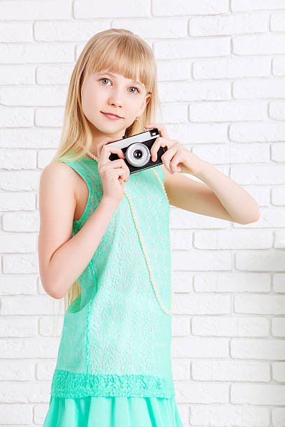 istock little girl holding a camera 529683538
