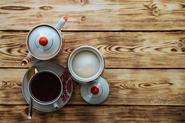 istock Tea cups with teapot on wooden table 529684258