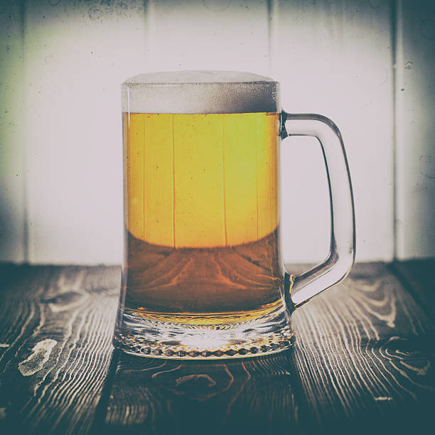 istock Mug of beer on wooden background 529684494
