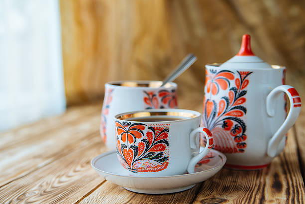 istock Tea cups with teapot on wooden table 529684680