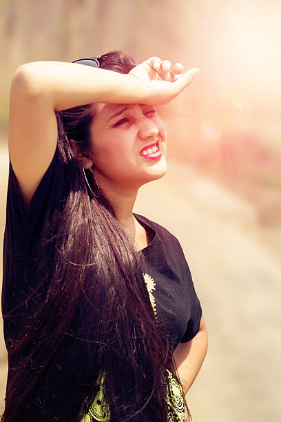 istock Woman shielding her eyes from sun 529685898