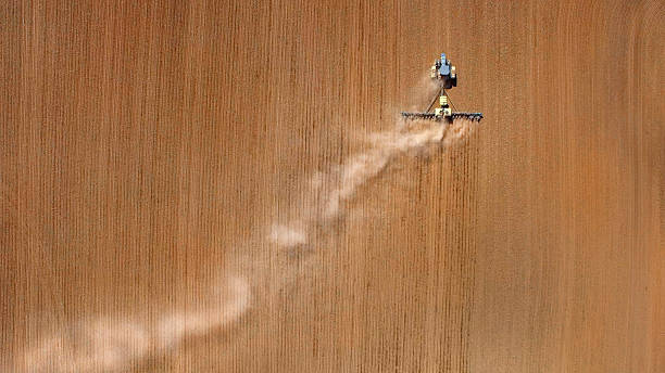 guardando verso il basso su agricole trattore piantare in primavera campi. - spraying agriculture farm herbicide foto e immagini stock