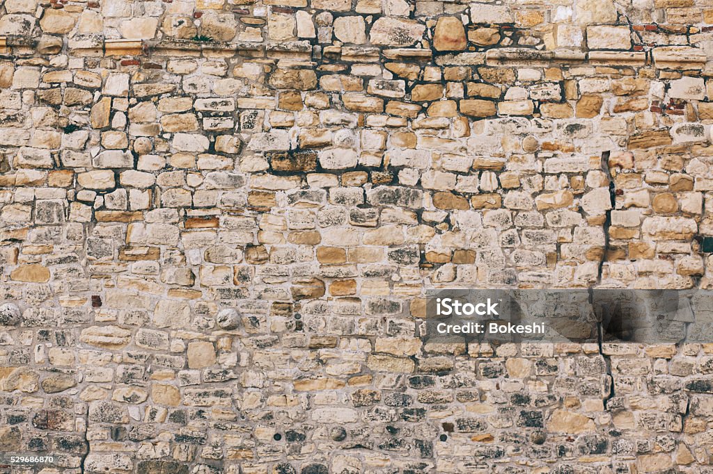 Stone wall texture Old stone wall texture. Fortified stone wall of an ancient fortress from the Roman Empire. Stone Wall Stock Photo