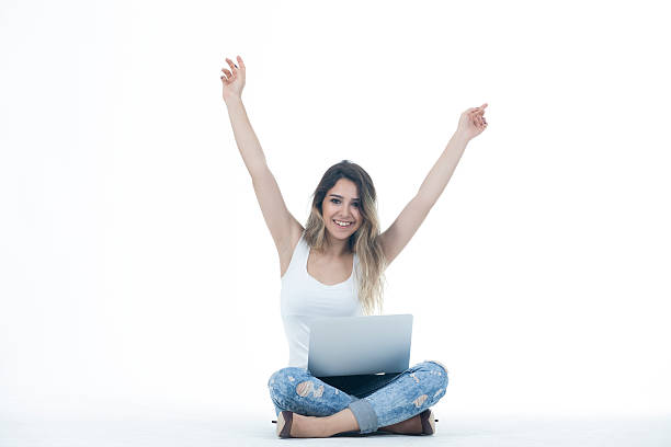 istock Female student with a laptop cheering in success 529687878