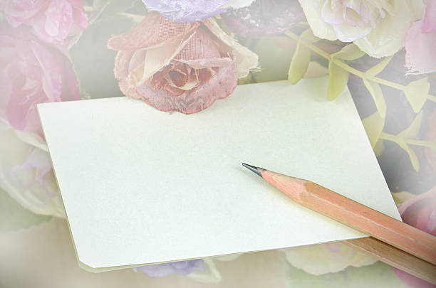 istock Note Paper and Pencil with Floral Background. 529690197