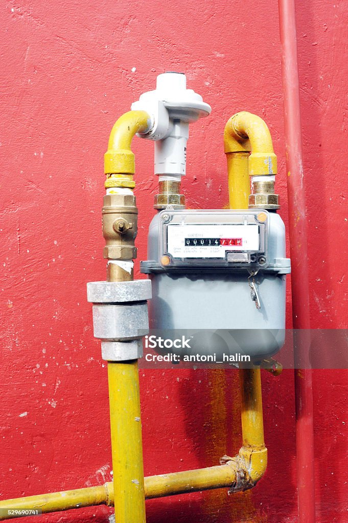 gas meter gas meter on the red wall Control Stock Photo